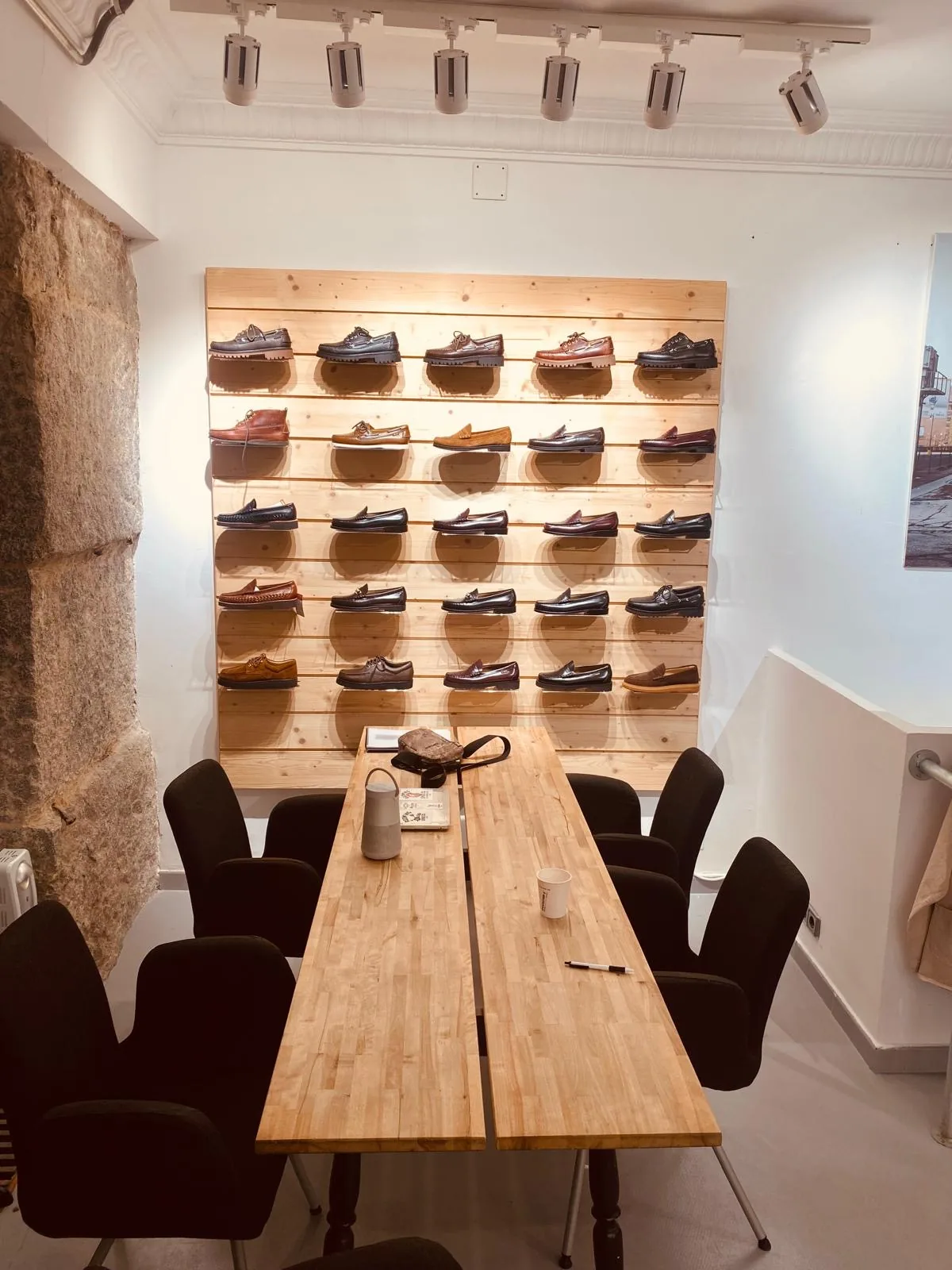 Buyer appointment table and footwear wall inside the Madrid showroom