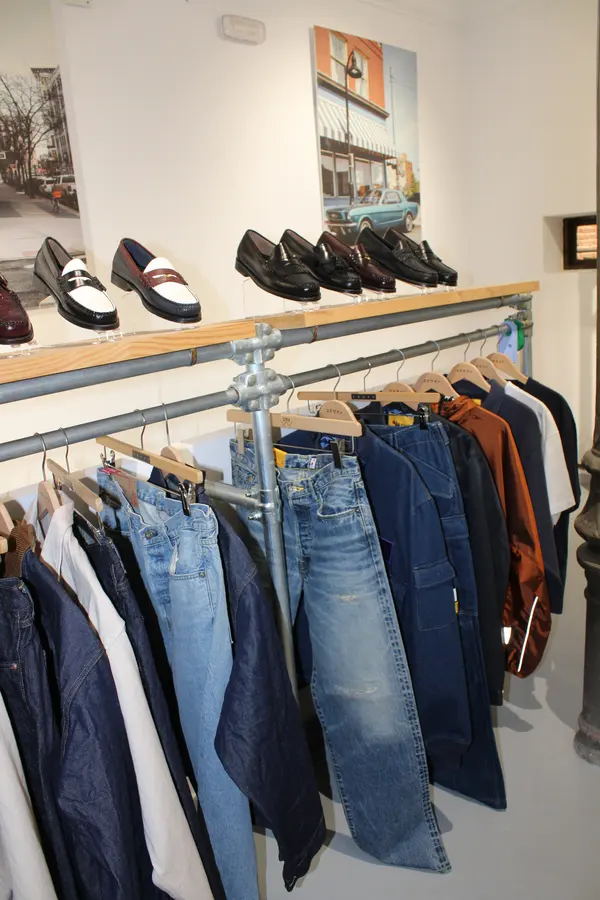 Denim rail below a loafer shelf in our Madrid showroom