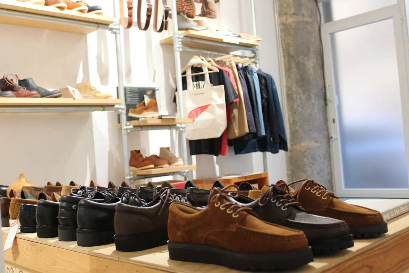Footwear presentation table with apparel rail behind in our Madrid showroom